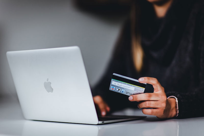 A woman who enters her bank details while shopping online